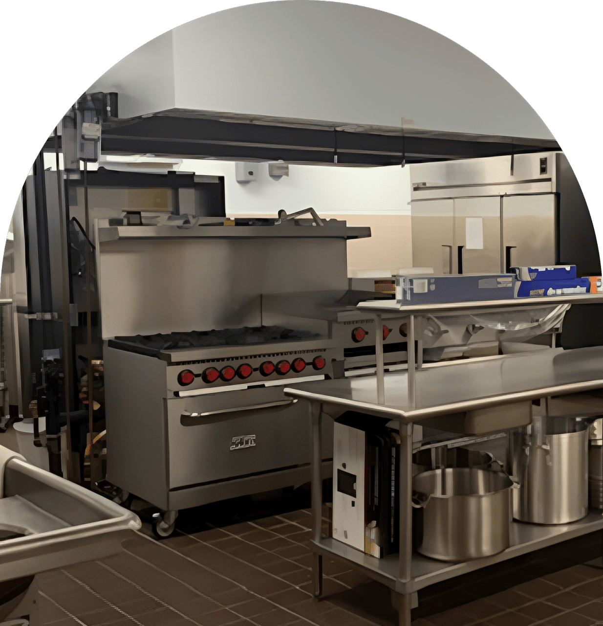Commercial kitchen with stainless steel equipment.