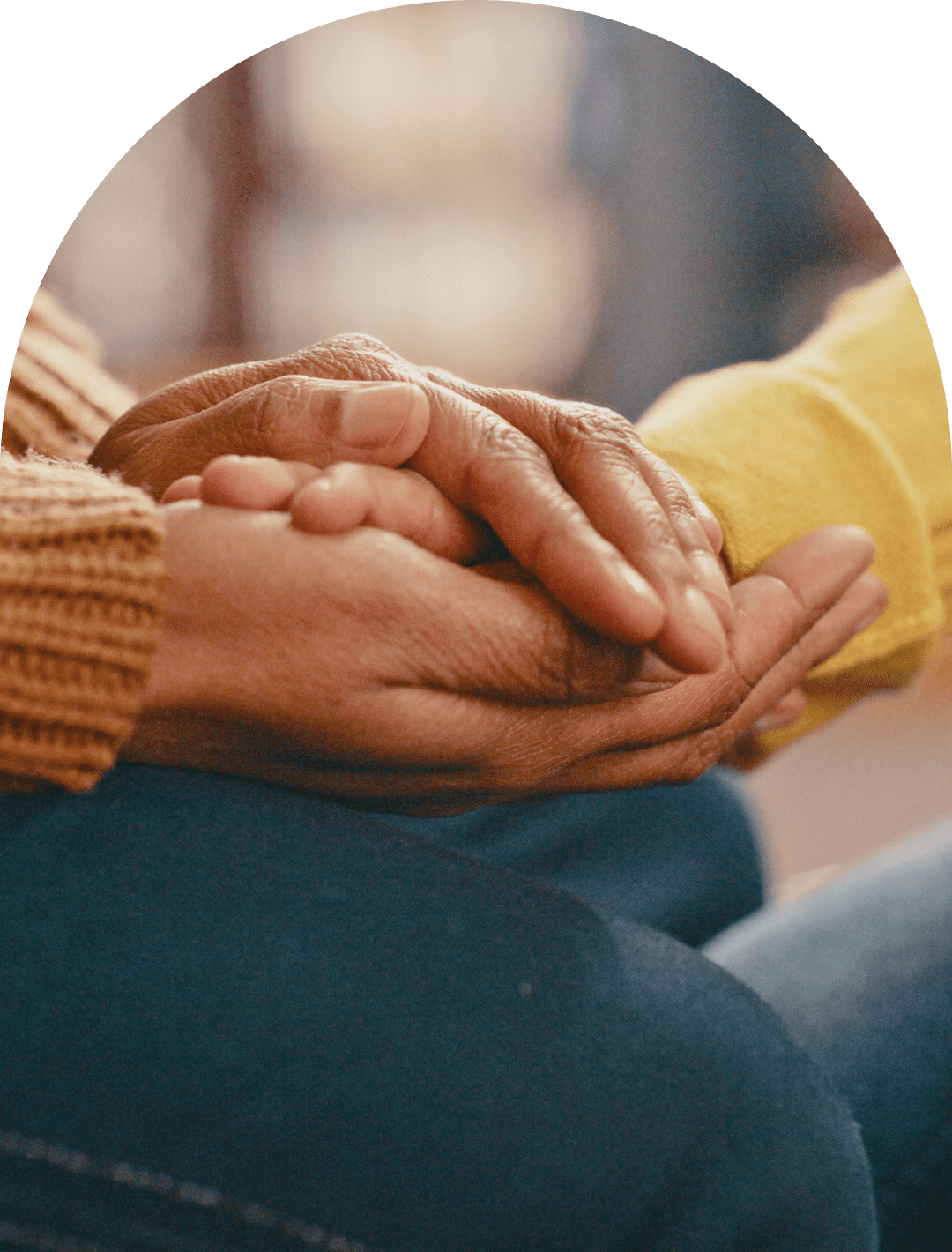 Hands gently holding each other, showing support.