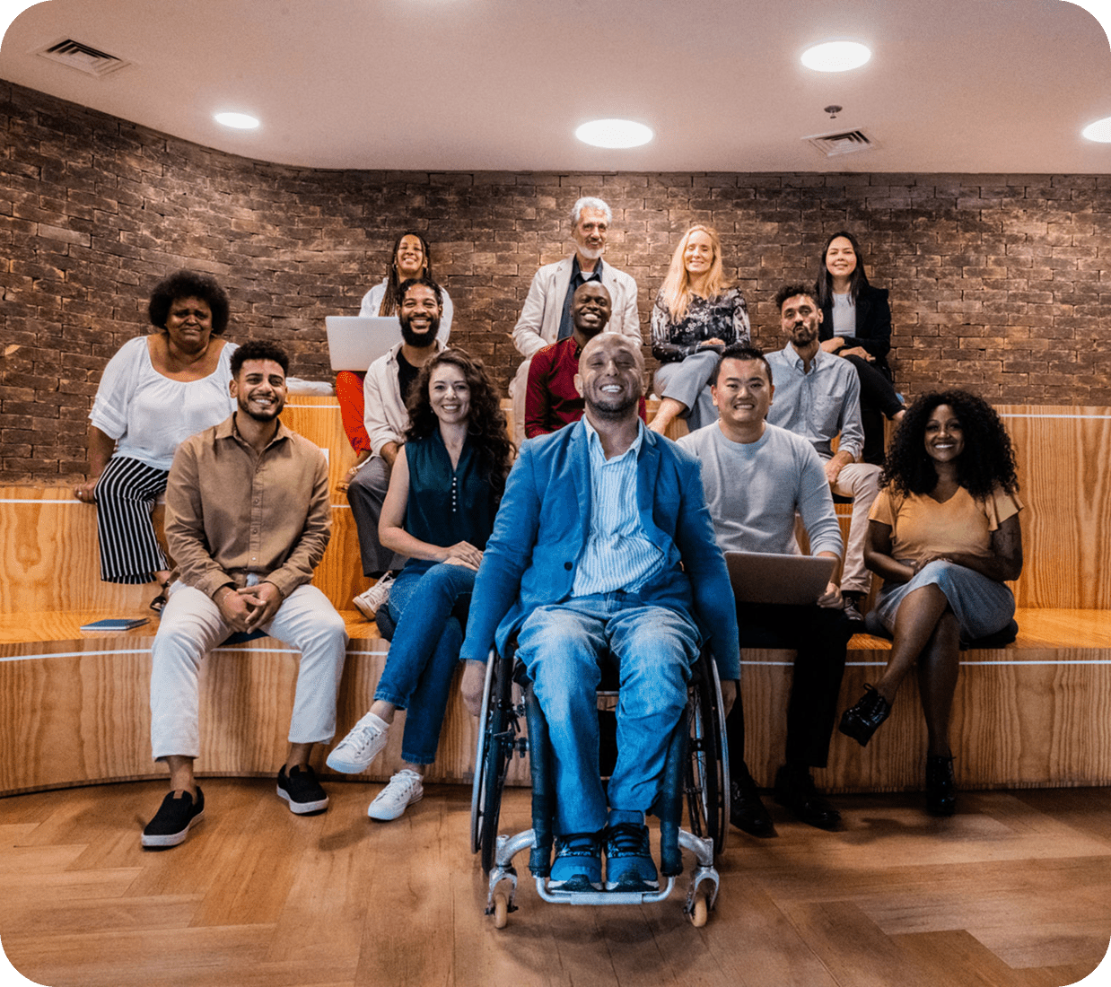 Diverse group of people sitting together smiling.