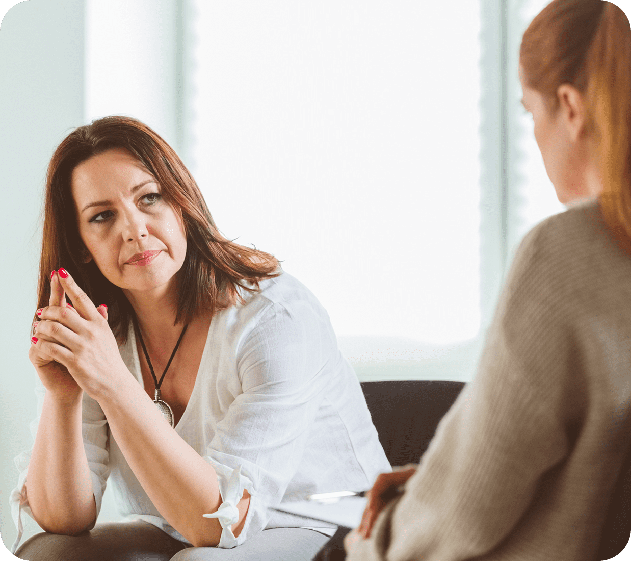 Two women in a thoughtful conversation.