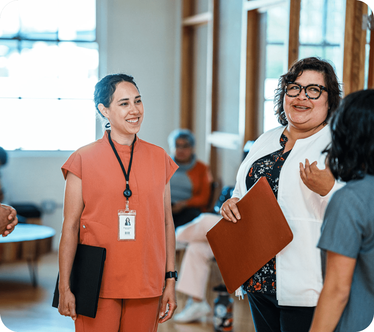 People talking and smiling in a room.